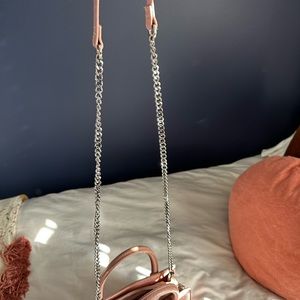 Pink leather purse with attached crossbody strap